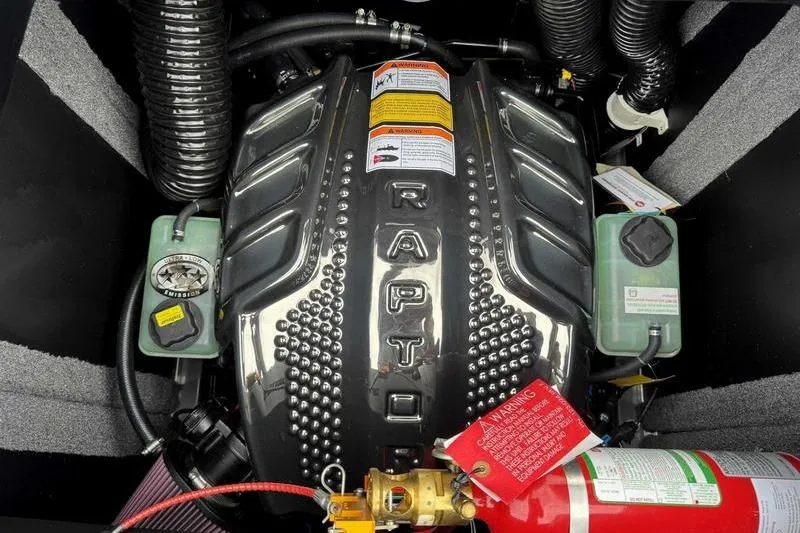 Slide: The Image of 2026 Supra SE boat rear view with SwellSurf technology, parked outdoors. - 6