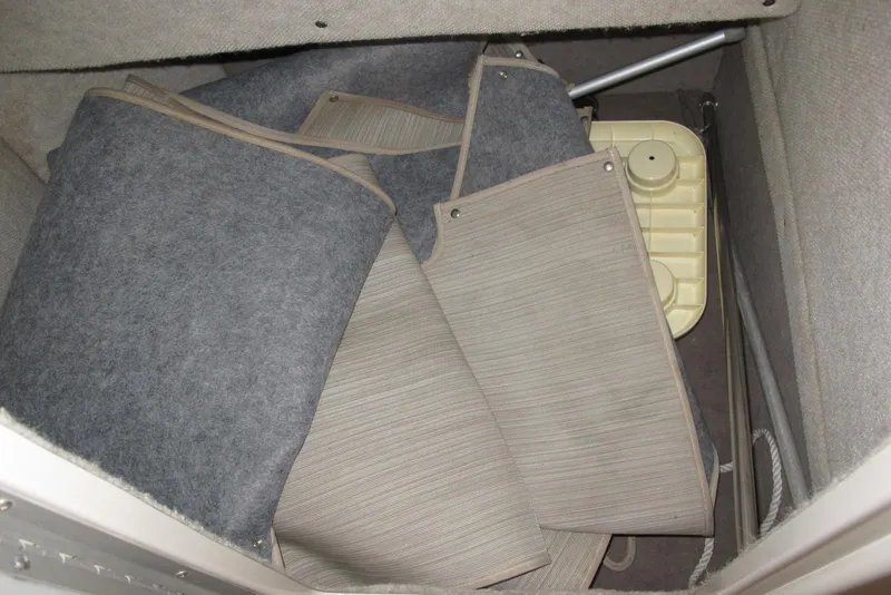 Slide: The Image of Storage compartment of 1995 Harris FloteBote Legend 240 with rolled mats and equipment. - 11