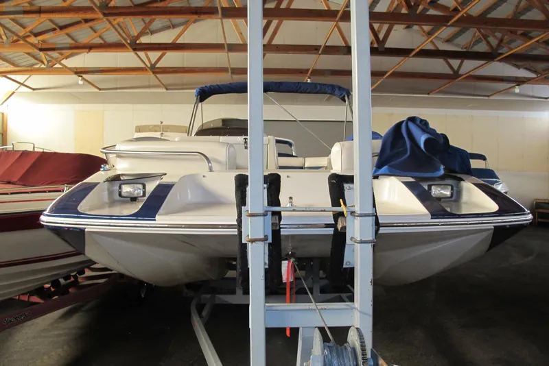 Slide: The Image of 1995 Harris FloteBote Legend 240 pontoon boat in indoor storage facility. - 2
