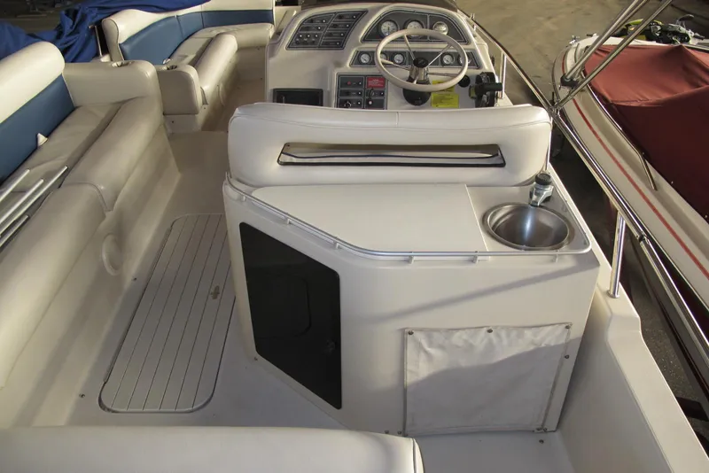 Slide: The Image of 1995 Harris FloteBote Legend 240 interior with helm, seating, and sink. - 5