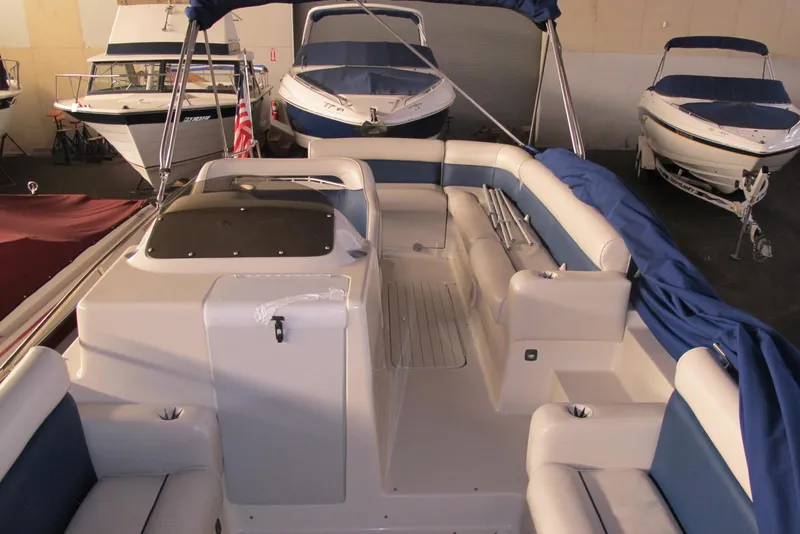 Slide: The Image of 1995 Harris FloteBote Legend 240 pontoon boat interior with blue and white seating. - 6