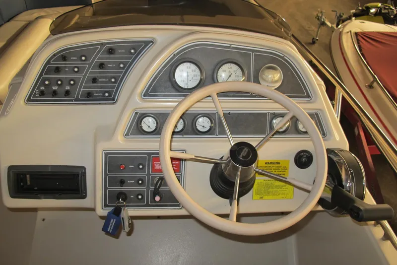 Slide: The Image of 1995 Harris FloteBote Legend 240 dashboard with steering wheel and control panel. - 8