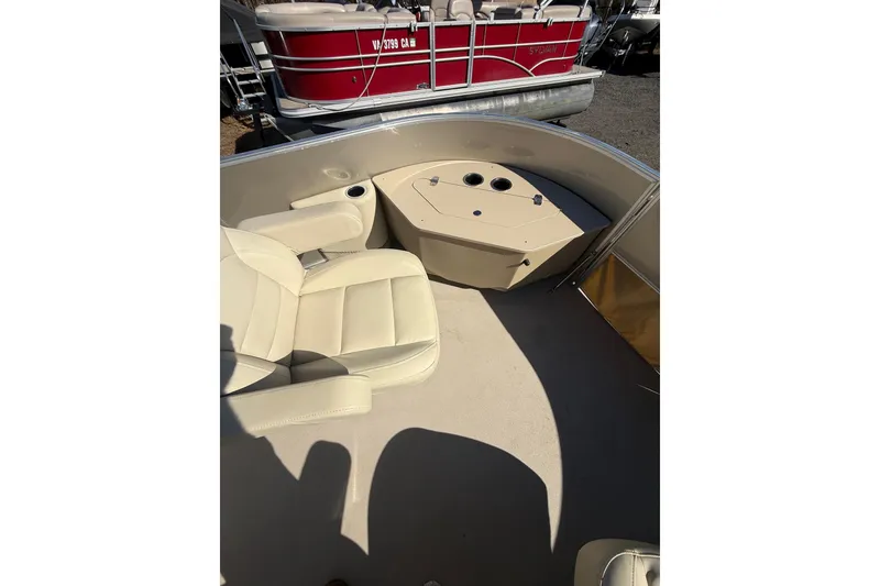 Slide: The Image of 2018 Sylvan Mirage Fish 8520 4-PT boat interior with beige seating and cup holders. - 14