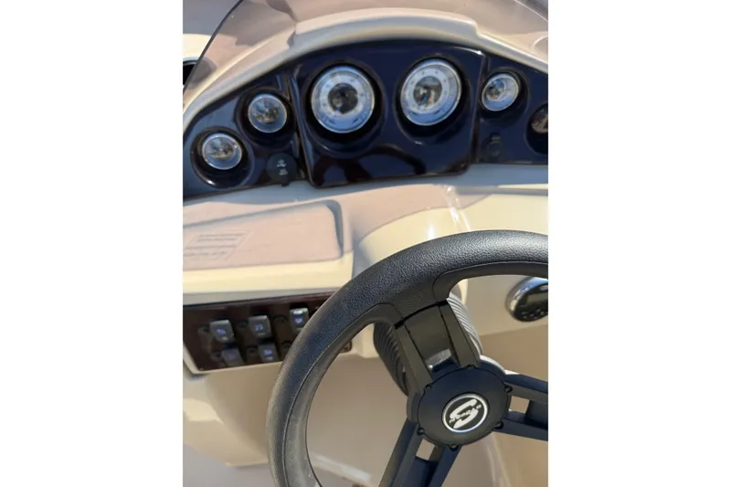 Slide: The Image of 2018 Sylvan Mirage Fish 8520 4-PT dashboard with steering wheel and gauges. - 19