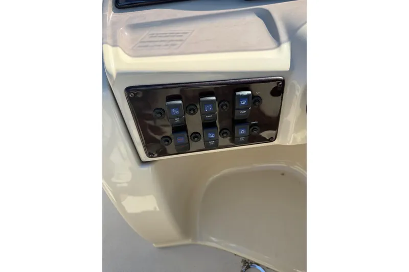 Slide: The Image of Control panel of 2018 Sylvan Mirage Fish 8520 4-PT boat with labeled switches. - 21