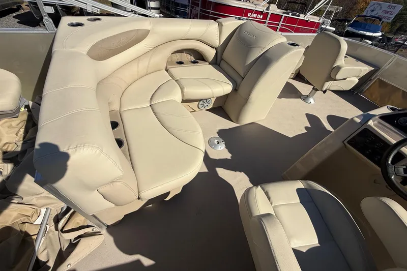 Slide: The Image of 2018 Sylvan Mirage Fish 8520 4-PT boat interior with beige seating and cup holders. - 24