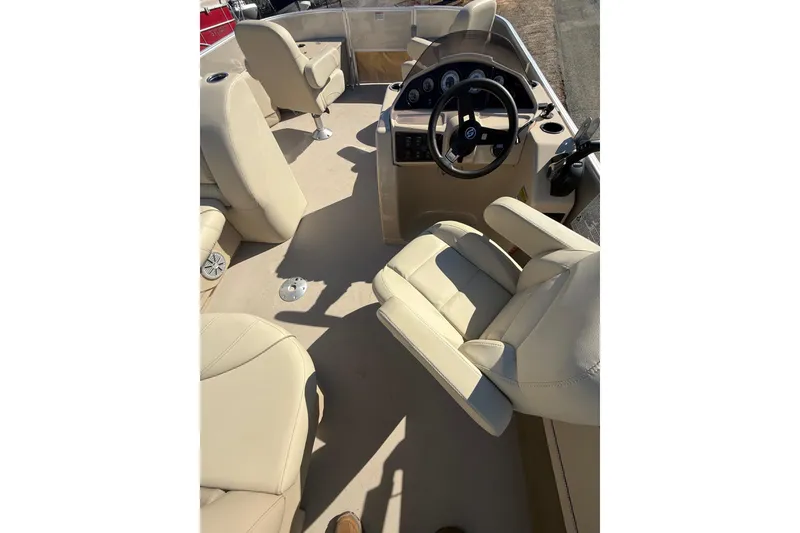 Slide: The Image of 2018 Sylvan Mirage Fish 8520 4-PT boat interior with beige seating and steering console. - 29