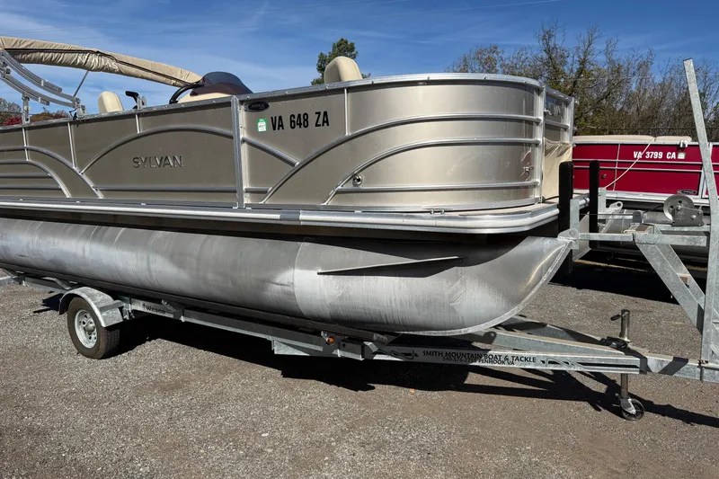 Slide: The Image of 2018 Sylvan Mirage Fish 8520 4-PT pontoon boat on trailer, parked outdoors. - 3