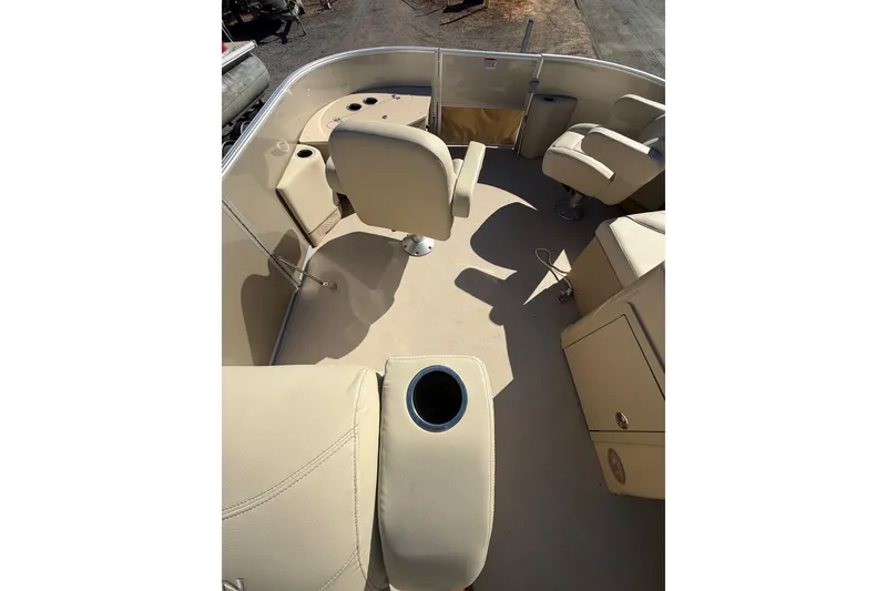 Slide: The Image of 2018 Sylvan Mirage Fish 8520 4-PT boat interior with beige seating and cup holder. - 30