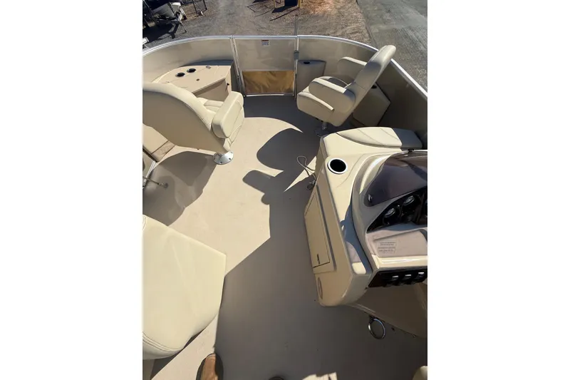 Slide: The Image of 2018 Sylvan Mirage Fish 8520 4-PT boat interior with beige seating and console. - 31