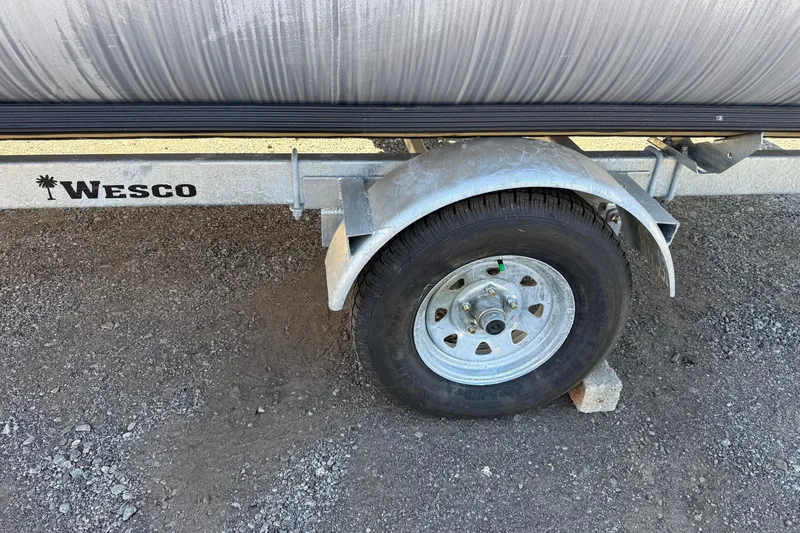 Slide: The Image of Trailer wheel of 2018 Sylvan Mirage Fish 8520 4-PT on gravel surface. - 8