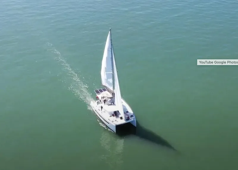 Slide: The Image of Aerial view of a 2021 Bali 4.8 sailboat cruising on calm waters. - 2