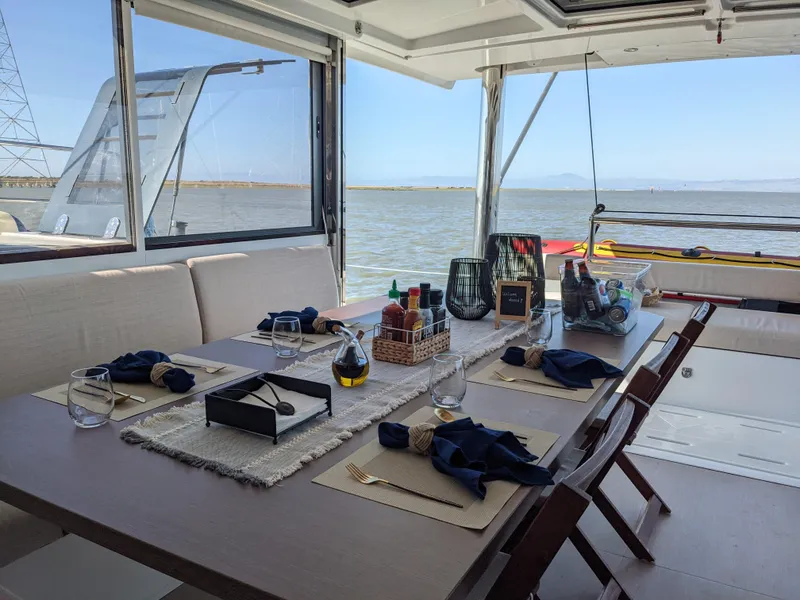 Slide: The Image of Luxurious dining setup on a 2021 Bali 4.8 yacht with ocean view. - 22