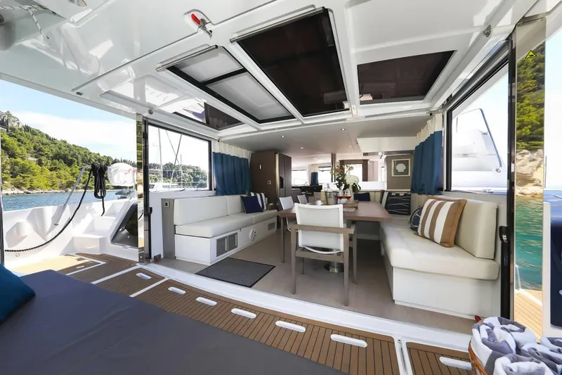 Slide: The Image of Luxurious Bali 4.8 yacht interior with spacious seating, dining area, and scenic ocean view. - 26
