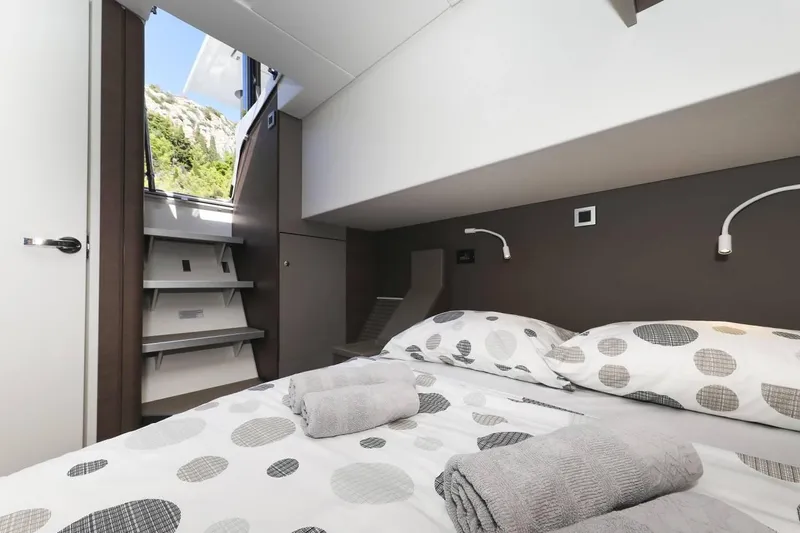 Slide: The Image of Interior of a 2021 Bali 4.8 yacht cabin with modern bedding and natural light. - 28