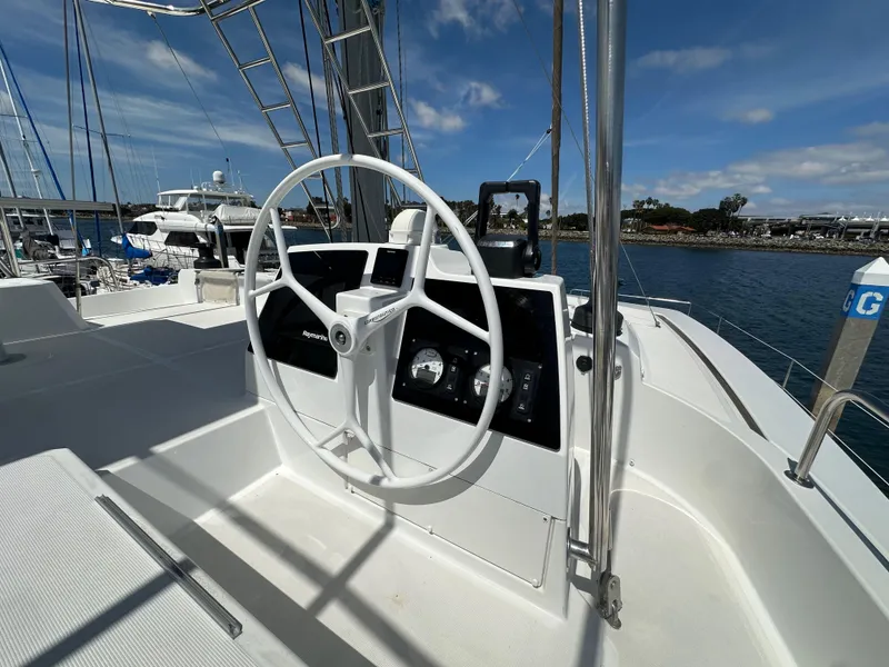 Slide: The Image of Steering wheel of a 2021 Bali 4.8 yacht docked at a marina. - 29