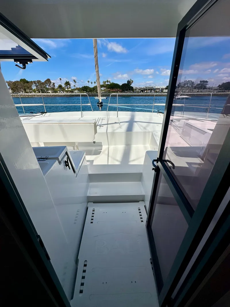 Slide: The Image of 2021 Bali 4.8 yacht interior with ocean view through open door. - 41
