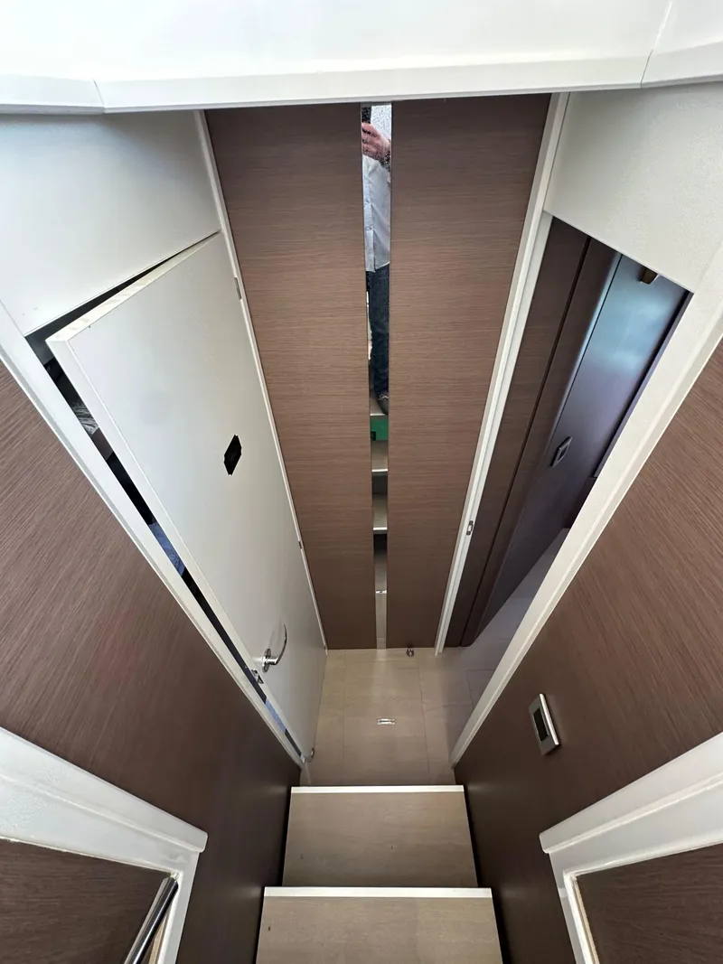 Slide: The Image of Interior view of a 2021 Bali 4.8 yacht, featuring a narrow hallway and modern design. - 43