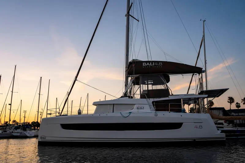 Slide: The Image of 2021 Bali 4.8 catamaran docked at sunset, showcasing sleek design and modern features. - 5