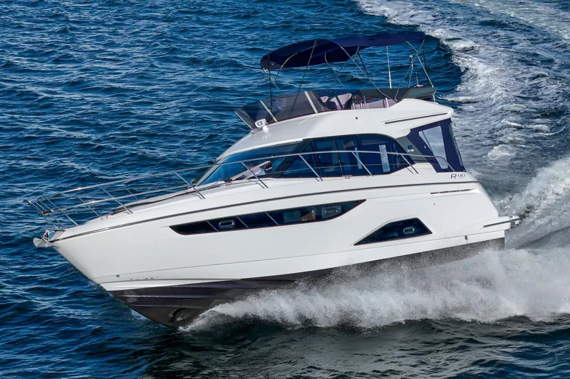 Slide: The Image of 2024 Bavaria R40 yacht cruising on open water, showcasing sleek design and performance. - 2