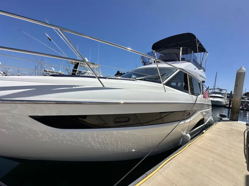 Slide: The Image of 2024 Bavaria R40 yacht docked at marina under clear blue sky. - 34