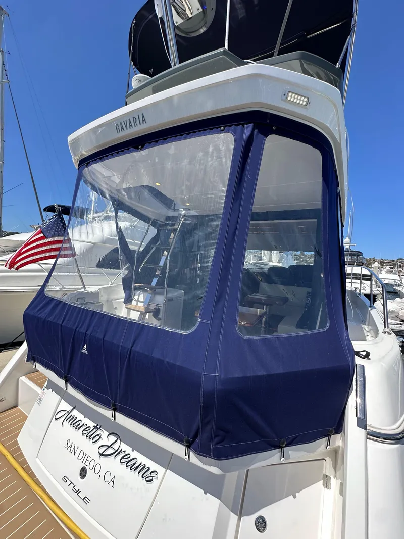 Slide: The Image of 2024 Bavaria R40 yacht with blue canopy, docked in San Diego marina. - 38