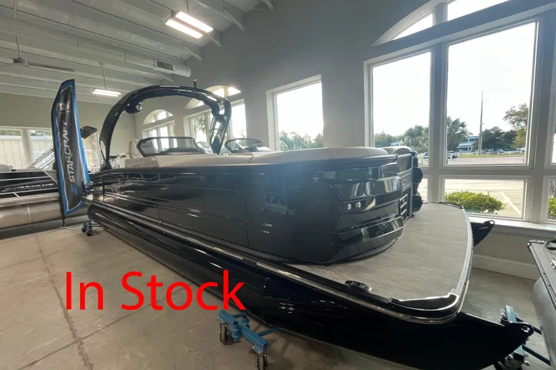 The Image of 2026 Starcraft RX 25 DL DC boat displayed indoors, labeled "In Stock." - 1