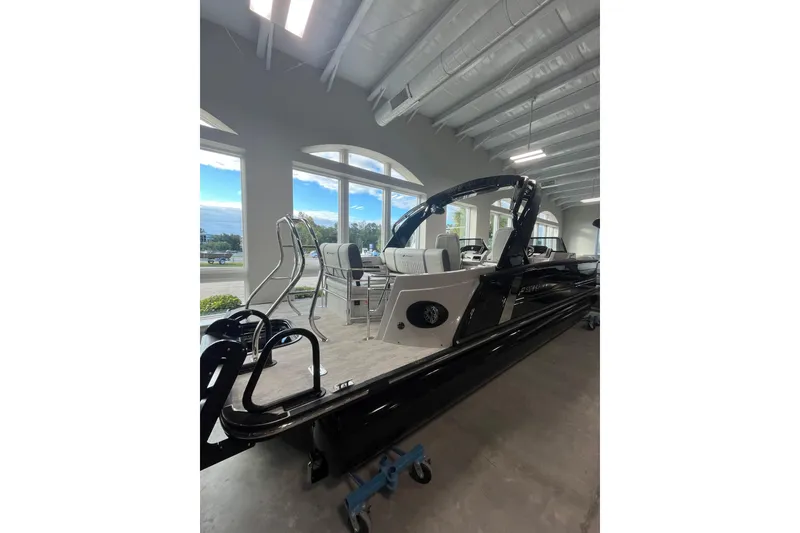 Slide: The Image of 2026 Starcraft RX 25 DL DC boat displayed indoors with modern seating and sleek design. - 3