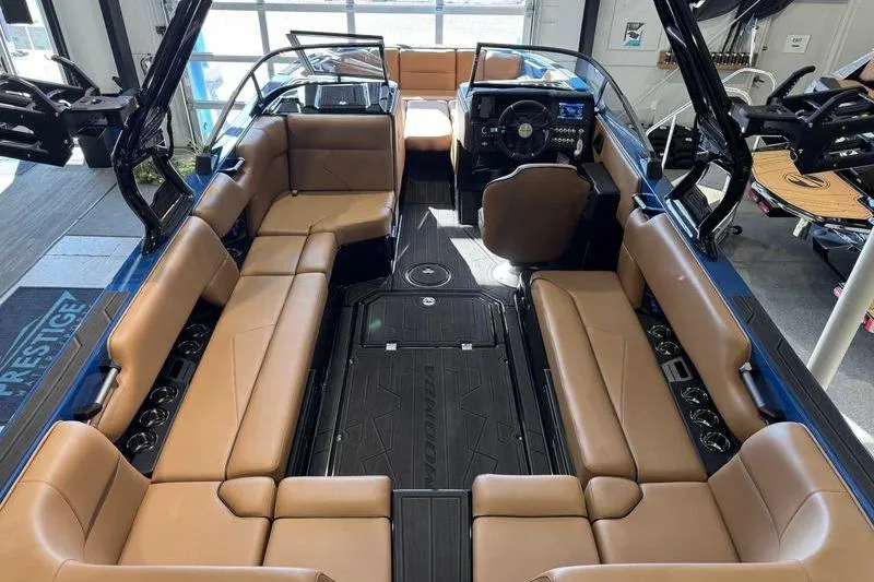 Slide: The Image of 2026 Moomba Tykon boat interior with tan seating and modern dashboard. - 10