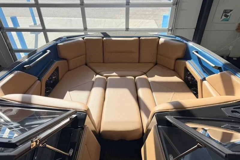 Slide: The Image of 2026 Moomba Tykon boat interior with tan seating and modern design. - 15