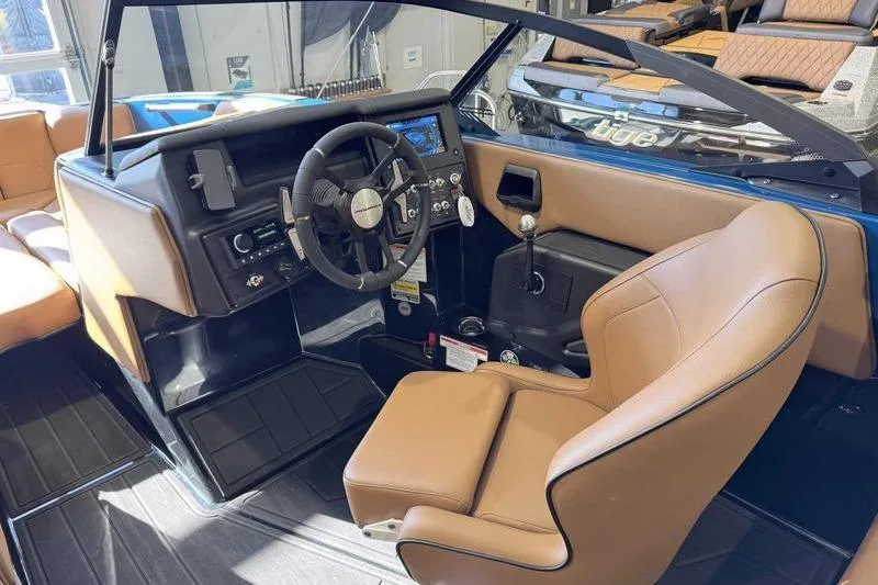 Slide: The Image of 2026 Moomba Tykon boat interior with tan seats and modern dashboard. - 8