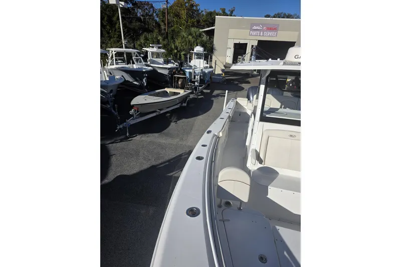 Slide: The Image of 2020 Sea Hunt Gamefish 30 Forward Seating boat at dealership, surrounded by other boats. - 5