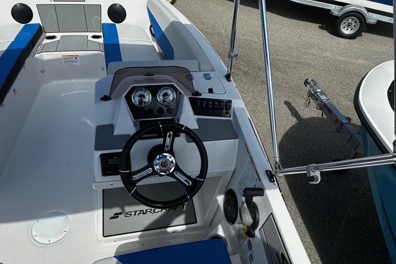 Slide: The Image of 2026 Starcraft SV 16 OB boat interior with steering wheel and dashboard controls. - 10