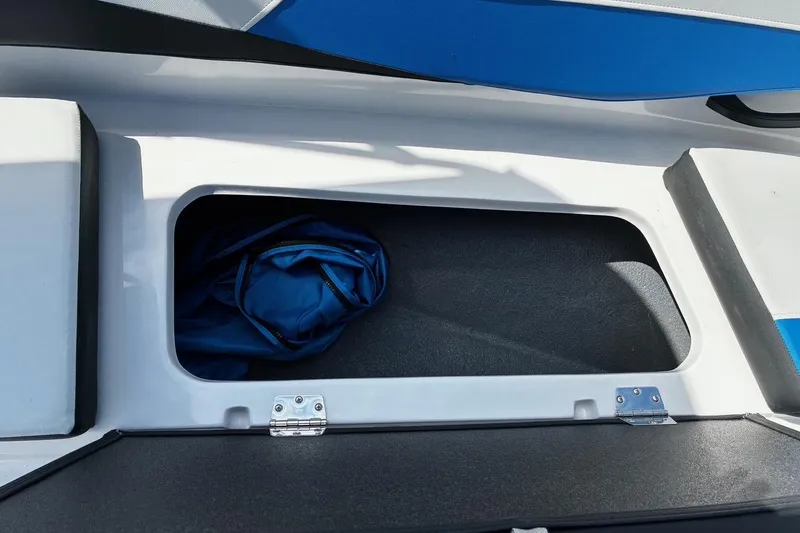 Slide: The Image of Storage compartment in 2026 Starcraft SV 16 OB boat, featuring blue fabric inside. - 12