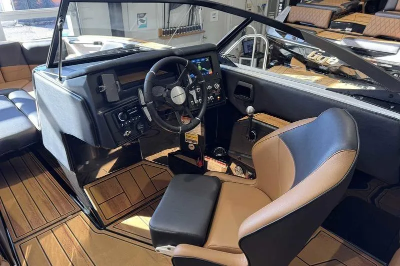 Slide: The Image of 2026 Moomba Tykon boat interior with modern dashboard and comfortable seating. - 11