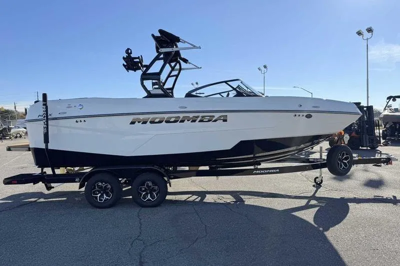 Slide: The Image of 2026 Moomba Tykon boat on trailer, parked outdoors under clear sky. - 4