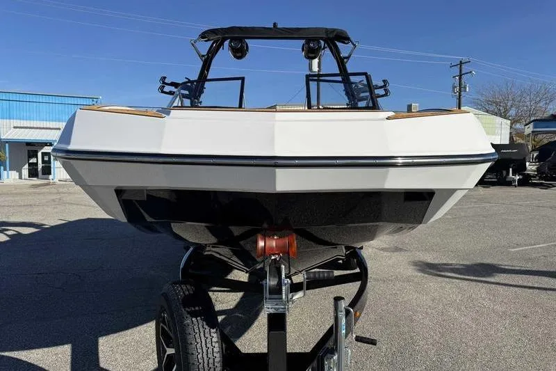 Slide: The Image of 2026 Moomba Tykon boat on trailer, front view, under clear blue sky. - 5