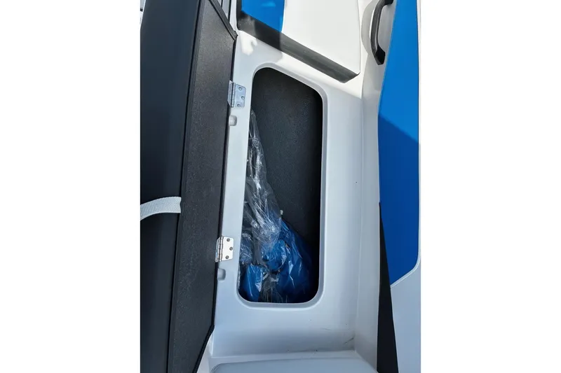 Slide: The Image of Storage compartment of 2026 Starcraft SV 16 OB boat, featuring sleek design and blue accents. - 13