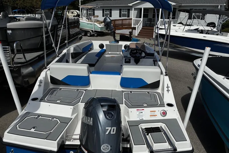 Slide: The Image of 2026 Starcraft SV 16 OB boat with Yamaha 70 engine, docked near other boats. - 6