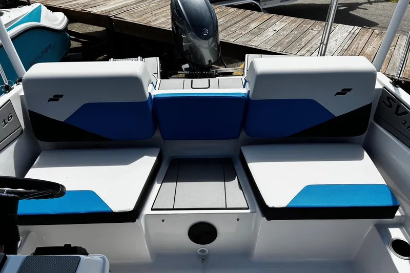 Slide: The Image of 2026 Starcraft SV 16 OB boat interior with blue and white seating, docked by wooden pier. - 9