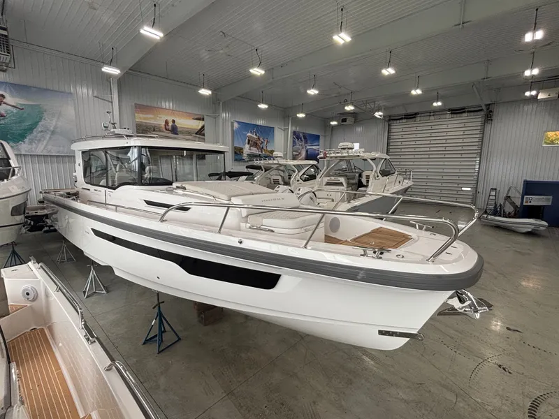 The Image of 2026 Nimbus Commuter 11 MKII Legacy Edition boat displayed in a showroom. - 0