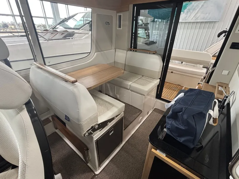 Slide: The Image of Interior of 2026 Nimbus Commuter 11 MKII Legacy Edition, featuring seating and table. - 11