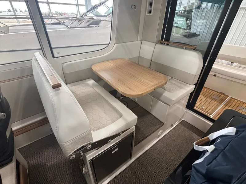 Slide: The Image of Interior of 2026 Nimbus Commuter 11 MKII Legacy Edition with cozy seating and wooden table. - 12