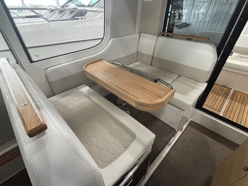Slide: The Image of Interior of 2026 Nimbus Commuter 11 MKII Legacy Edition with elegant seating and wooden table. - 13