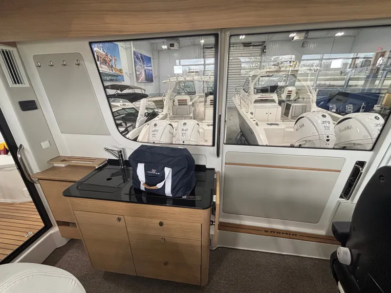 Slide: The Image of Interior of 2026 Nimbus Commuter 11 MKII Legacy Edition with kitchenette and marina view. - 16