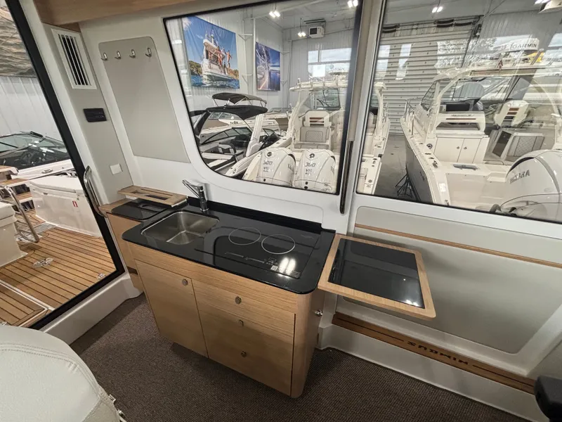 Slide: The Image of Interior of 2026 Nimbus Commuter 11 MKII Legacy Edition with modern kitchenette and sleek design. - 17