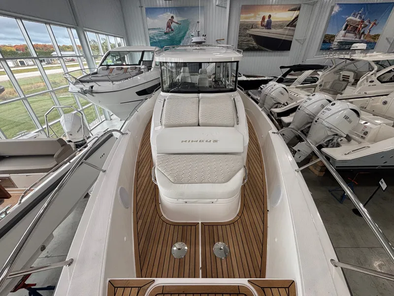 Slide: The Image of 2026 Nimbus Commuter 11 MKII Legacy Edition boat in showroom, featuring sleek design and luxurious seating. - 7