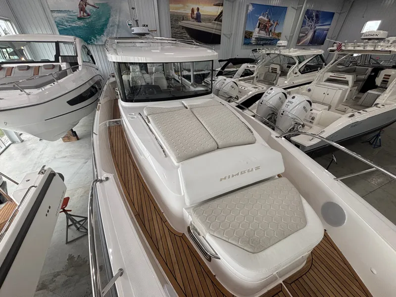 Slide: The Image of Nimbus Commuter 11 MKII Legacy Edition 2026 yacht in showroom, featuring sleek design and luxury seating. - 9