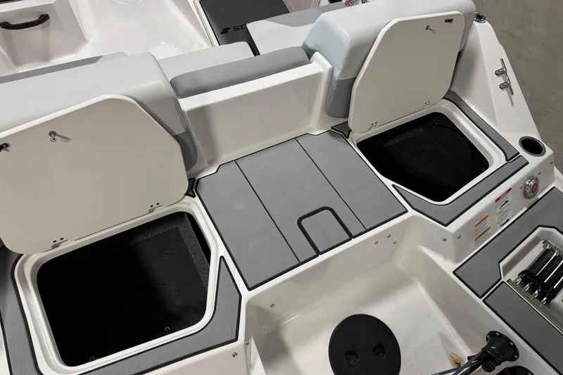 Slide: The Image of 2026 Starcraft SV 16 OB boat interior with open storage compartments and seating. - 10