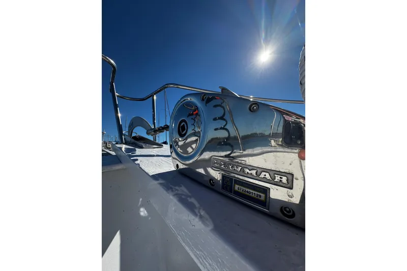 Slide: The Image of 1982 Marine Trader Europa boat with white exterior, docked under clear blue sky. - 12